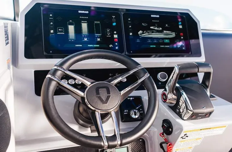 Slide: The Image of Steering wheel and controls of 2025 Navan S30 boat with digital displays. - 13