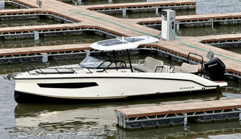 Slide: The Image of 2026 Navan S30 boat docked at marina, featuring sleek design and modern amenities. - 2