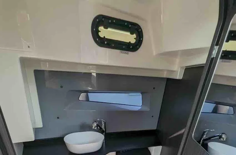 Slide: The Image of Interior of 2025 Navan S30 boat bathroom with sink and window. - 20
