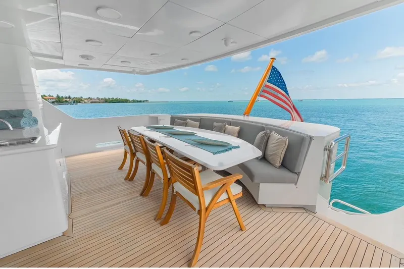 Slide: The Image of Luxurious 2001 Intermarine RPH 95 yacht deck with dining area and ocean view. - 23