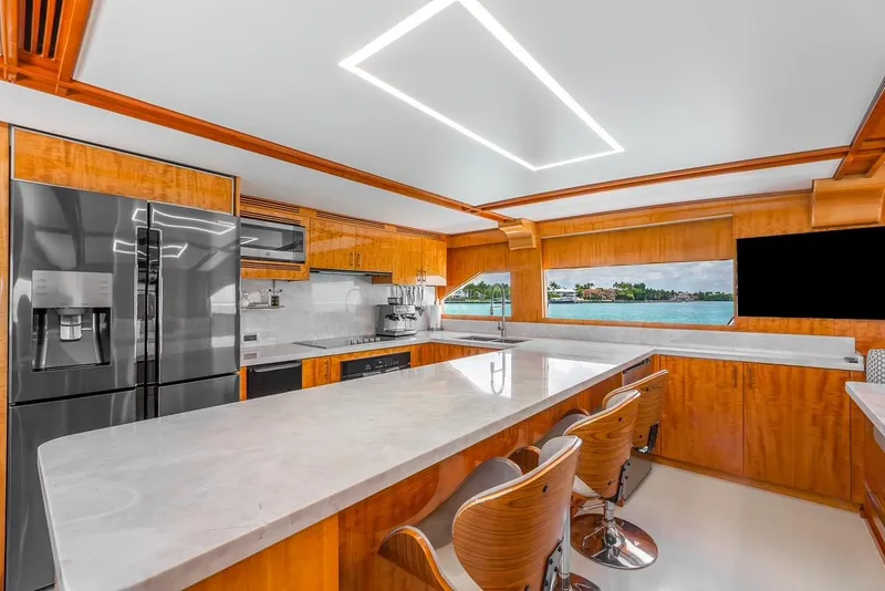 Slide: The Image of Luxurious kitchen interior of 2001 Intermarine RPH 95 yacht with modern appliances and wood finishes. - 25