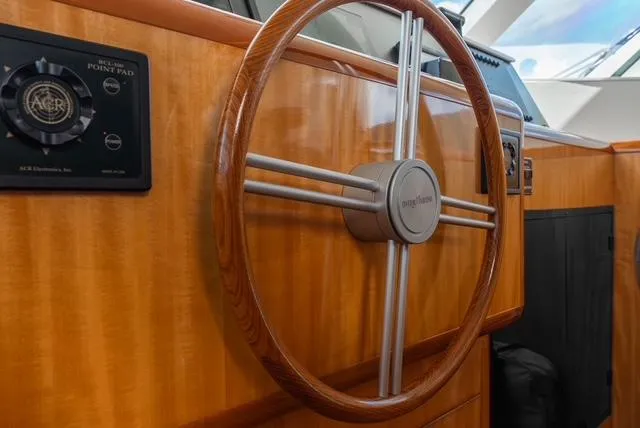Slide: The Image of Steering wheel of 2001 Intermarine RPH 95 yacht, featuring wood and metal design. - 29