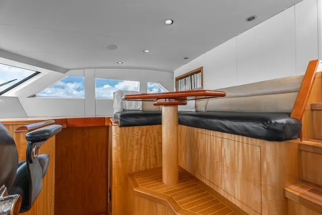 Slide: The Image of Luxurious interior of 2001 Intermarine RPH 95 yacht with wooden finishes and seating area. - 30