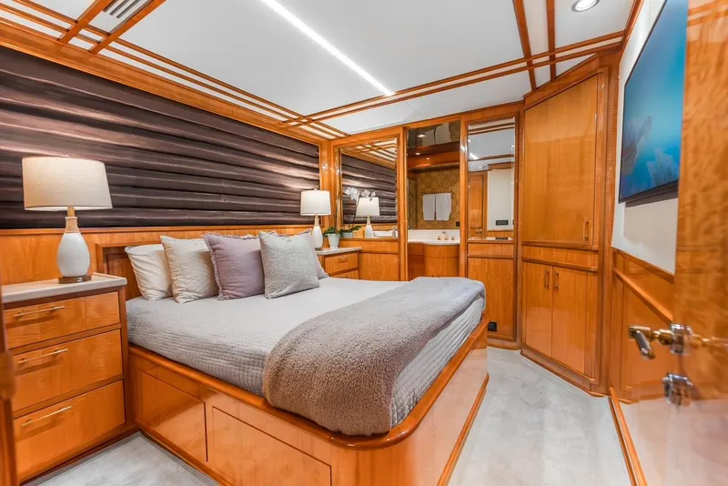 Slide: The Image of Luxurious bedroom interior on 2001 Intermarine RPH 95 yacht with wood accents and modern decor. - 33
