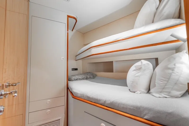 Slide: The Image of Bunk beds in 2001 Intermarine RPH 95 yacht cabin, featuring cozy bedding and wooden accents. - 41