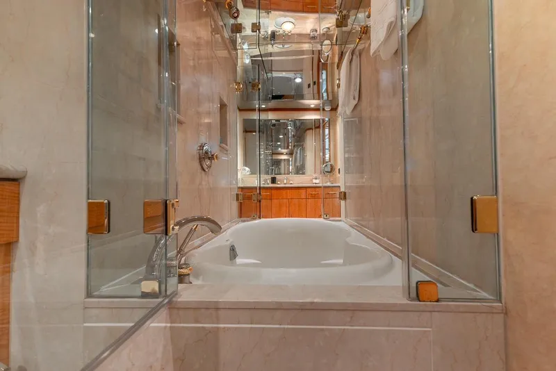 Slide: The Image of Luxurious bathroom with glass shower and bathtub on 2001 Intermarine RPH 95 yacht. - 43
