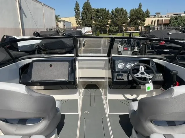 Slide: The Image of 2025 Bayliner V20 boat interior with modern dashboard and dual seating. - 12