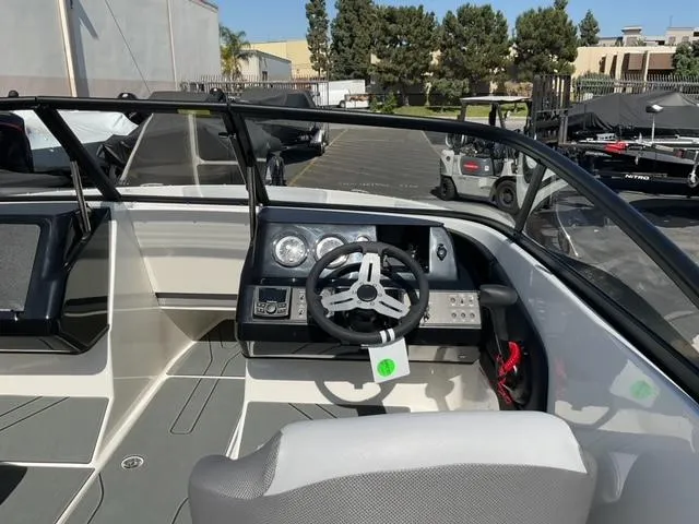 Slide: The Image of 2025 Bayliner V20 boat interior with modern dashboard and steering wheel. - 13