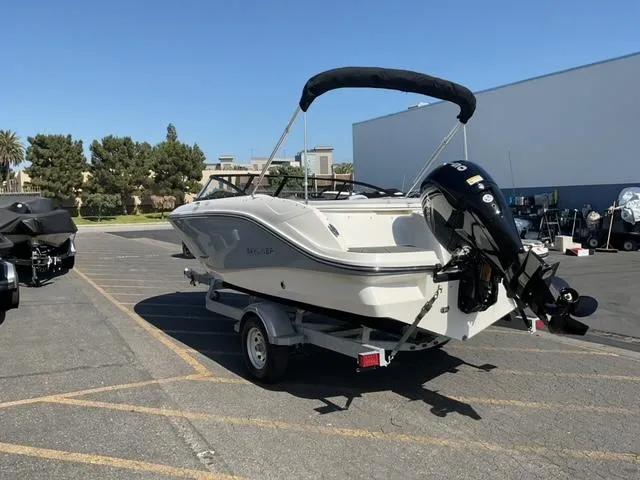 Slide: The Image of 2025 Bayliner V20 boat on trailer in parking lot, sunny day. - 4