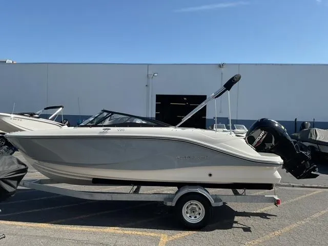 Slide: The Image of 2025 Bayliner V20 boat on trailer, parked outdoors under clear sky. - 5