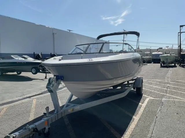 Slide: The Image of 2025 Bayliner V20 boat on trailer in sunny outdoor setting. - 6