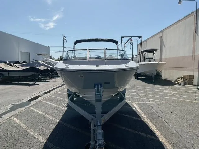Slide: The Image of 2025 Bayliner V20 boat on trailer in outdoor parking lot. - 7