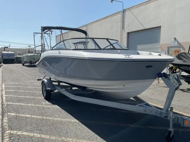 Slide: The Image of 2025 Bayliner V20 boat on trailer in parking lot, side view. - 8