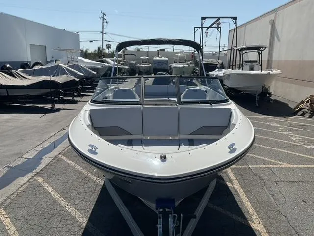 Slide: The Image of 2025 Bayliner V20 boat on trailer in outdoor showroom. - 9