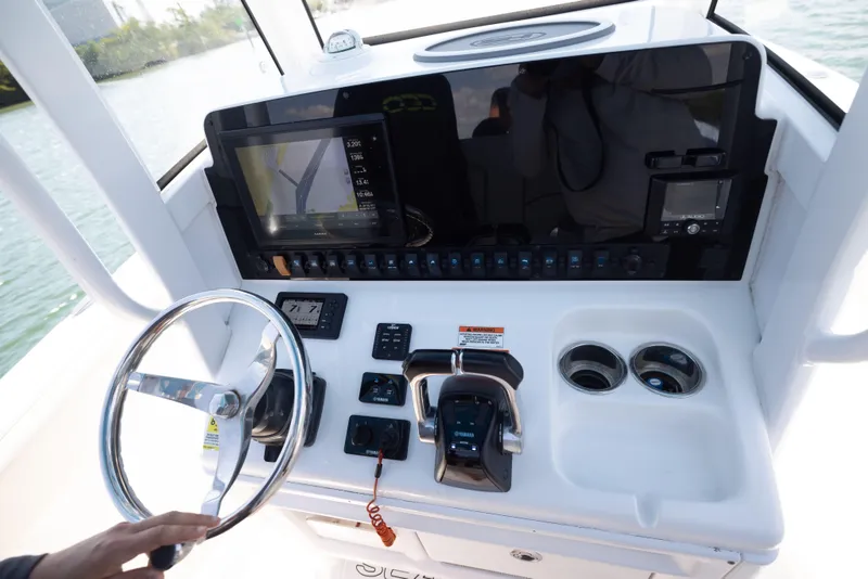 Slide: The Image of 2020 Sea Hunt GAMEFISH boat dashboard with steering wheel and navigation controls. - 10