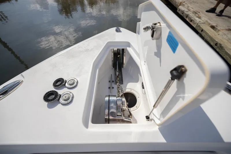Slide: The Image of 2020 Sea Hunt GAMEFISH boat anchor compartment with open hatch and visible chain mechanism. - 15