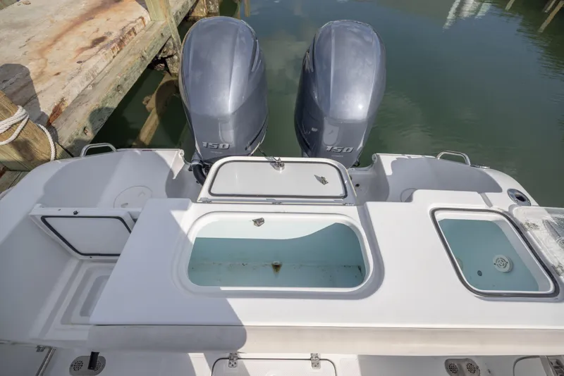 Slide: The Image of 2020 Sea Hunt GAMEFISH boat with dual 150 horsepower engines at dock. - 16