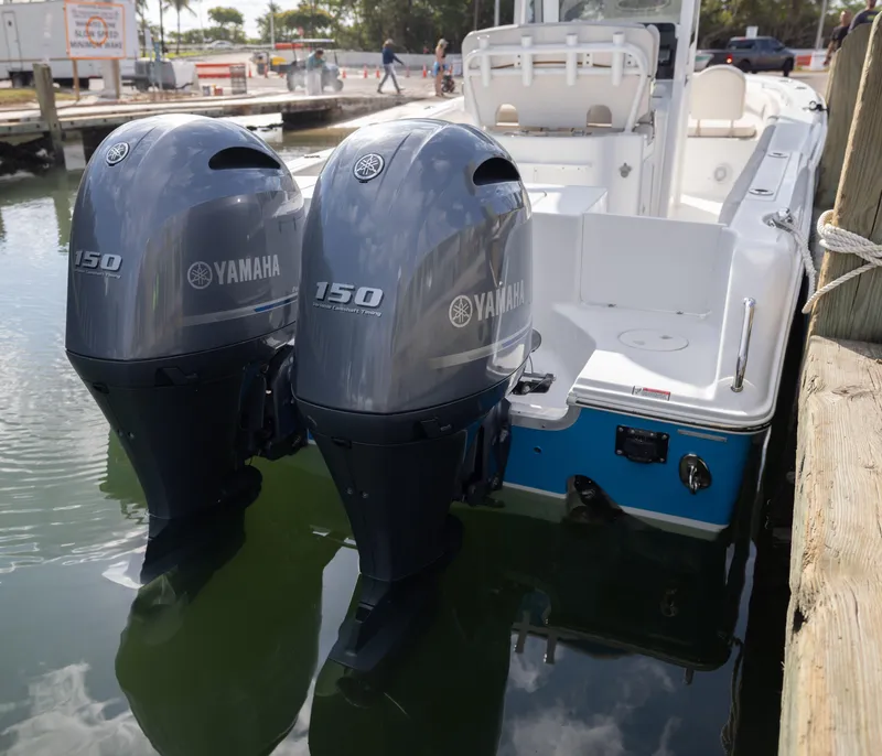Slide: The Image of 2020 Sea Hunt GAMEFISH boat with dual Yamaha 150 engines docked at marina. - 17