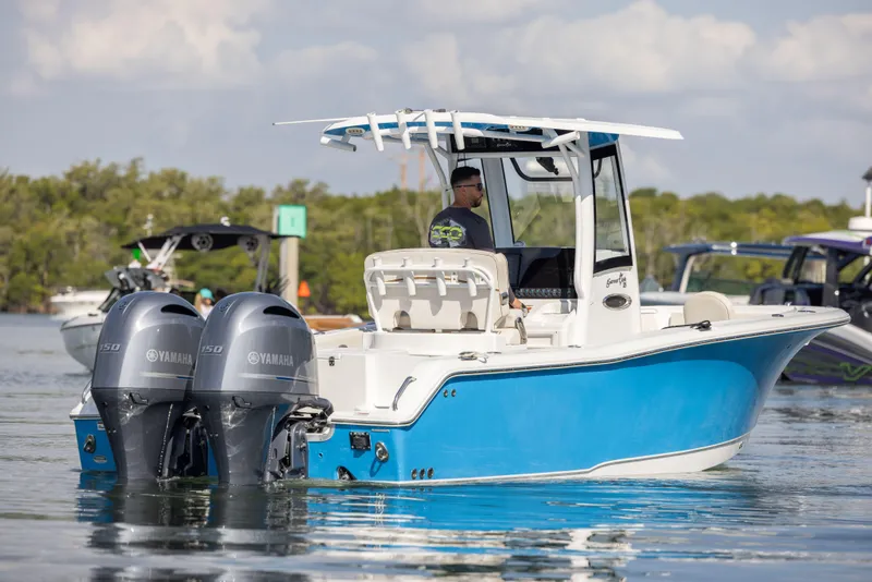 Slide: The Image of 2020 Sea Hunt GAMEFISH boat with dual Yamaha engines on a calm waterway. - 2