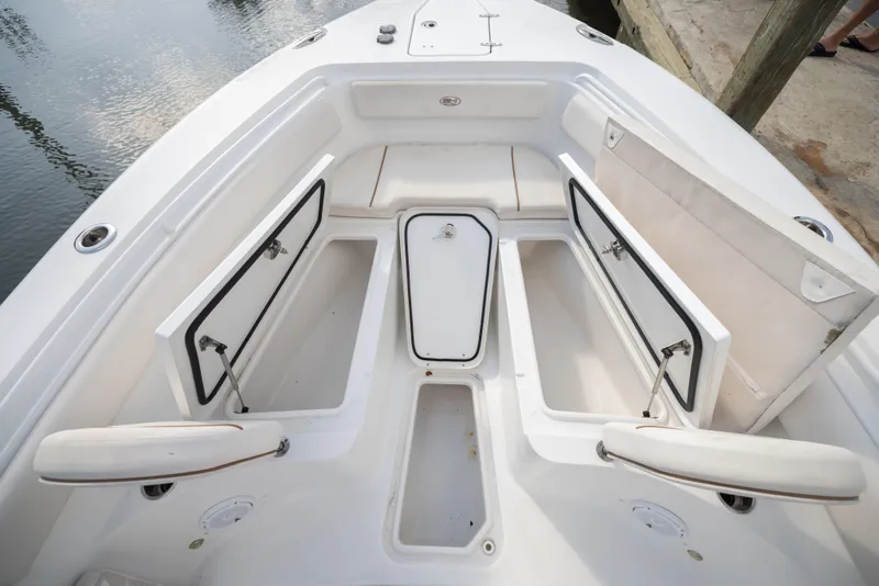 Slide: The Image of 2020 Sea Hunt GAMEFISH boat with open storage compartments and seating area. - 8