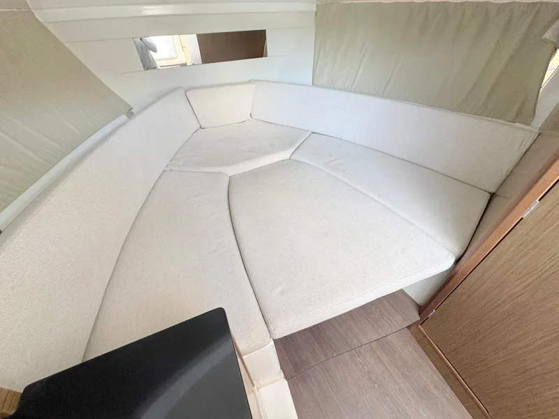 Slide: The Image of Cozy interior cabin of 2018 Jeanneau Leader 9.0 WA with cushioned seating. - 13