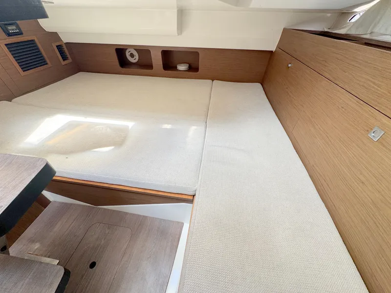 Slide: The Image of 2018 Jeanneau Leader 9.0 WA cabin interior with wooden finish and cushioned seating. - 17