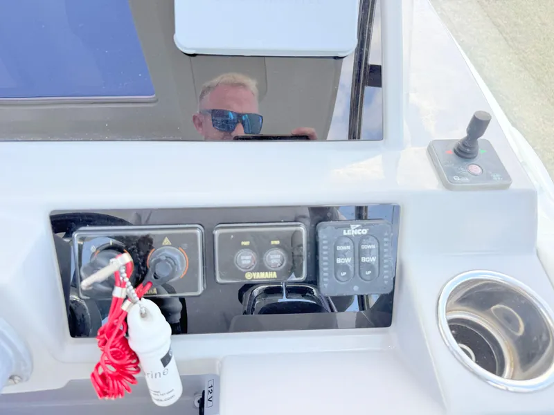 Slide: The Image of Control panel of 2018 Jeanneau Leader 9.0 WA boat with Yamaha controls and cup holder. - 23