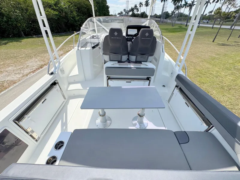 Slide: The Image of 2018 Jeanneau Leader 9.0 WA boat interior with seating and table, outdoor setting. - 27