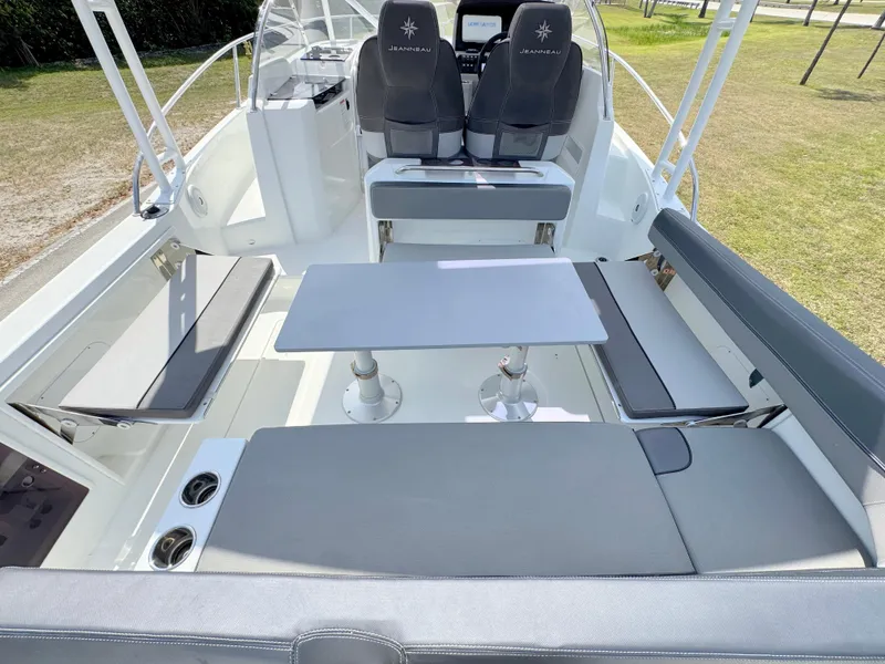 Slide: The Image of 2018 Jeanneau Leader 9.0 WA boat interior with seating and table setup. - 28