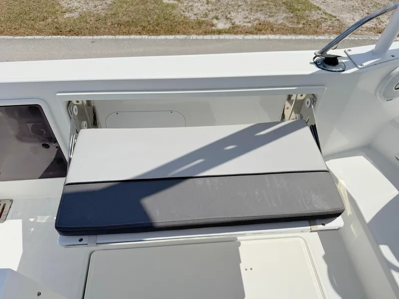 Slide: The Image of 2018 Jeanneau Leader 9.0 WA boat seat with storage compartment, outdoor setting. - 31