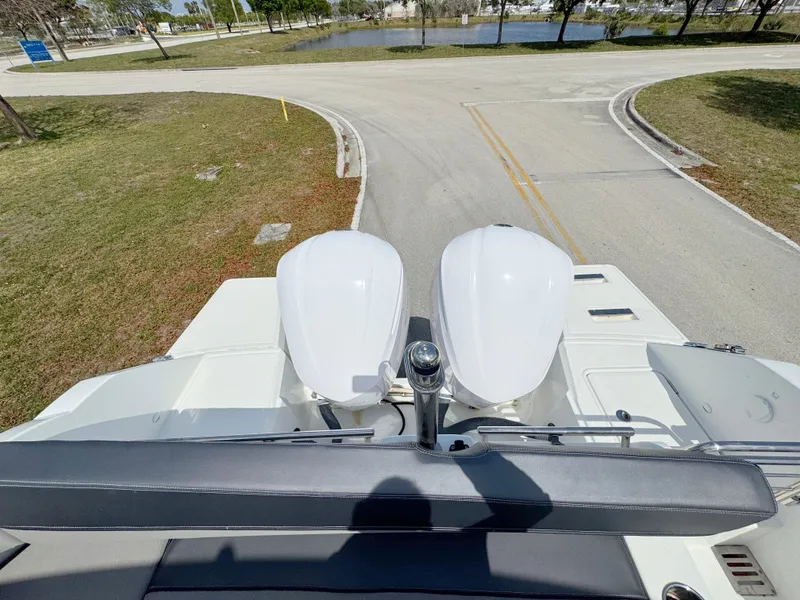 Slide: The Image of 2018 Jeanneau Leader 9.0 WA boat with dual engines, parked on a road. - 33