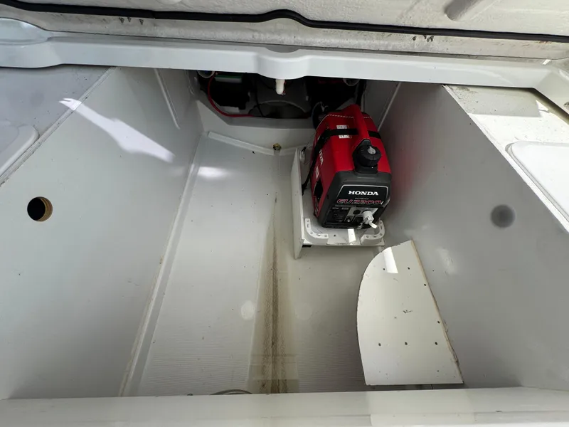 Slide: The Image of Storage compartment of a 2018 Jeanneau Leader 9.0 WA with a red generator inside. - 34
