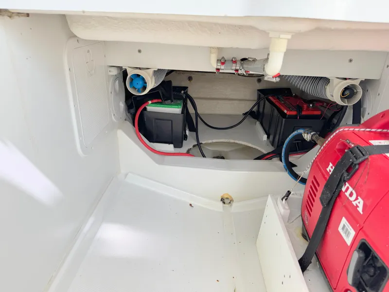 Slide: The Image of 2018 Jeanneau Leader 9.0 WA engine compartment with batteries and Honda generator. - 36