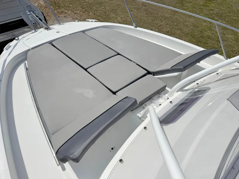 Slide: The Image of 2018 Jeanneau Leader 9.0 WA boat with spacious sunbathing deck and cushioned seating. - 9