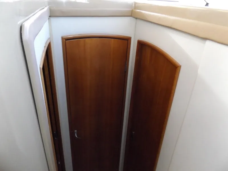 Slide: The Image of 2003 Carver 360 Sport Sedan interior with wooden doors and beige walls. - 12