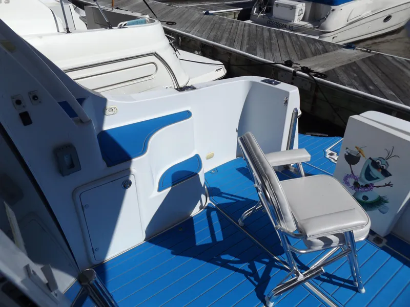 Slide: The Image of 2003 Carver 360 Sport Sedan boat deck with blue flooring and seating. - 15