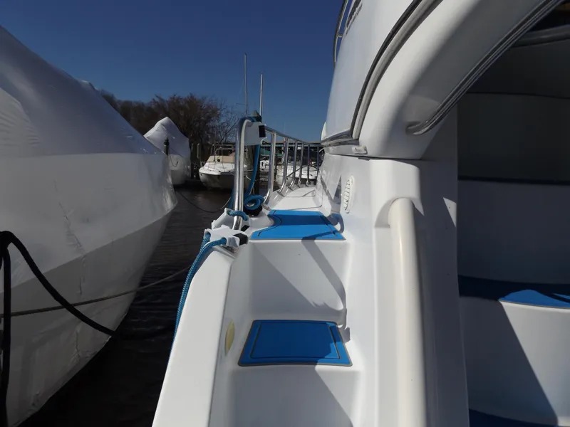 Slide: The Image of 2003 Carver 360 Sport Sedan yacht docked, showcasing sleek design and blue accents. - 16