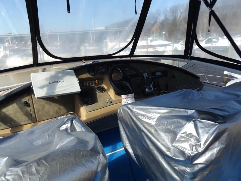 Slide: The Image of 2003 Carver 360 Sport Sedan cockpit with Garmin navigation, covered seats, and clear windows. - 18