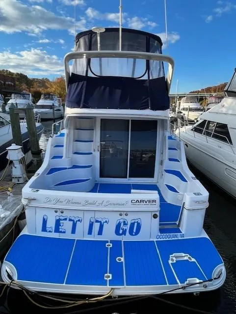 Slide: The Image of 2003 Carver 360 Sport Sedan docked, featuring blue and white design, "Let It Go" text. - 2