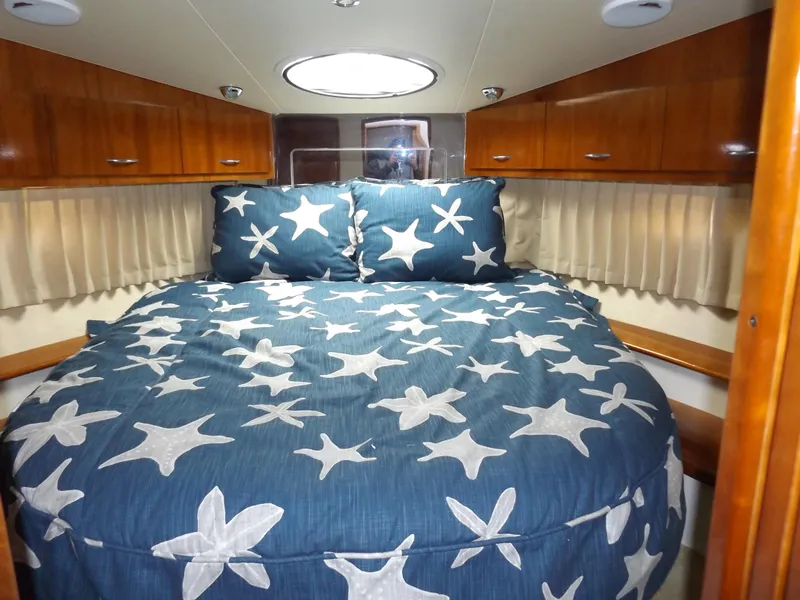 Slide: The Image of Cozy bedroom in 2003 Carver 360 Sport Sedan with starfish-themed bedding. - 27