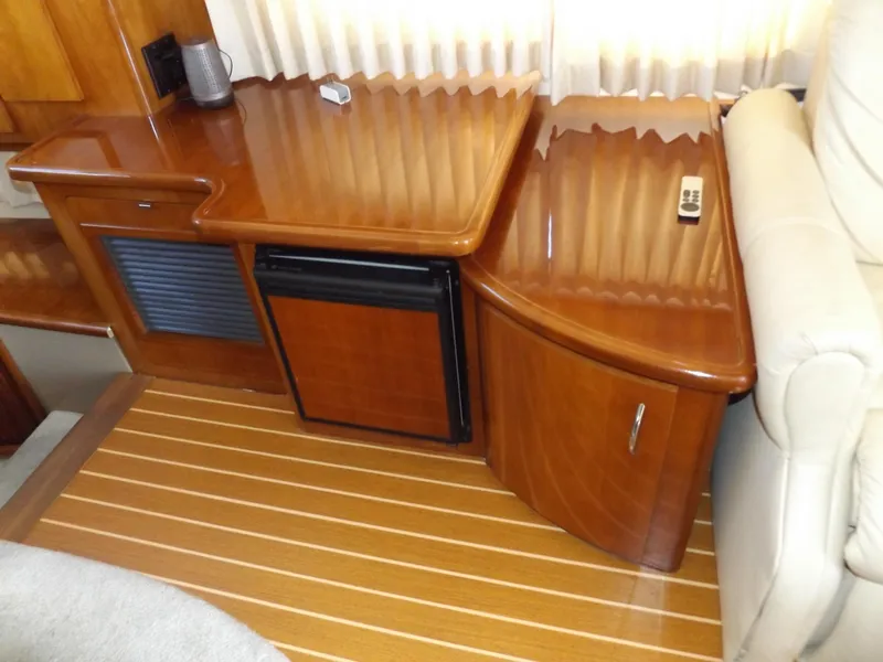 Slide: The Image of 2003 Carver 360 Sport Sedan interior with wooden cabinetry and mini fridge. - 32