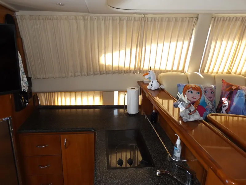 Slide: The Image of Interior of 2003 Carver 360 Sport Sedan with kitchen and plush toys on sofa. - 34