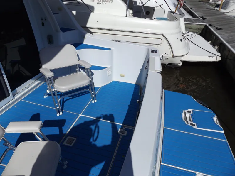 Slide: The Image of 2003 Carver 360 Sport Sedan with blue deck and seating at marina. - 41