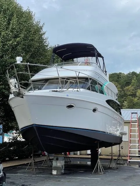 Slide: The Image of 2003 Carver 360 Sport Sedan yacht on stands, outdoor setting, overcast sky. - 43