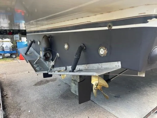 Slide: The Image of Rear view of a 2003 Carver 360 Sport Sedan boat with propeller and trim tabs. - 46