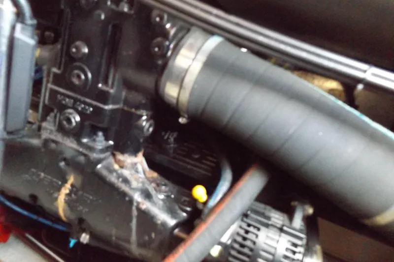 Slide: The Image of Close-up of a 2003 Carver 360 Sport Sedan engine component with hoses and connectors. - 48