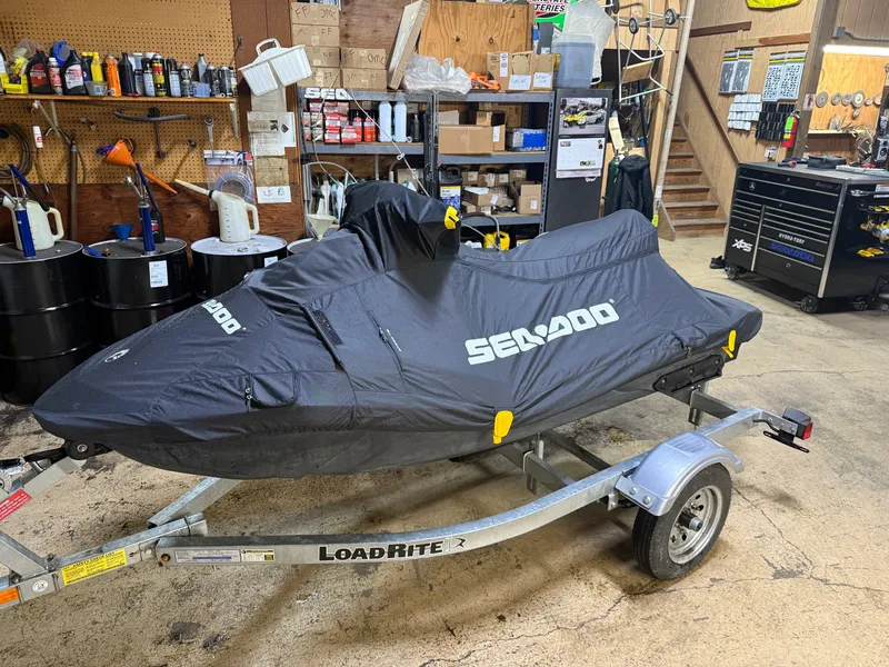 Slide: The Image of 2015 Sea-Doo Spark 3up 900 H.O. ACE jet ski covered in a garage on a trailer. - 6