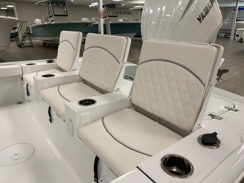 Slide: The Image of 2025 Sea Hunt BX 22 BR boat interior with cushioned seating and cup holders. - 6