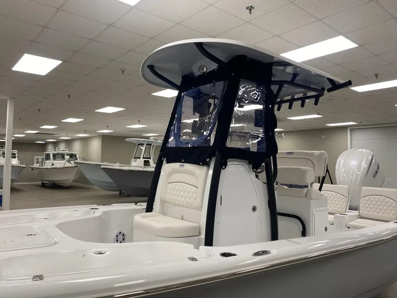 Slide: The Image of 2025 Sea Hunt BX 22 BR boat in showroom, featuring sleek design and modern seating. - 8