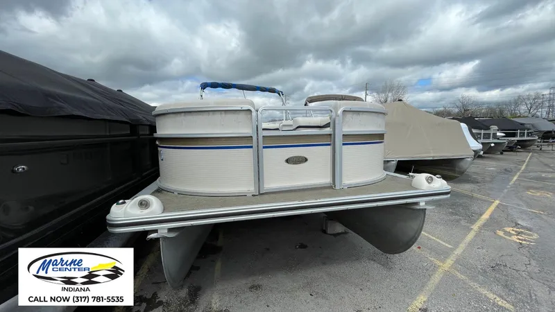 Slide: The Image of 2007 Harris Sunliner 220 pontoon boat in a marina, cloudy sky background. - 2